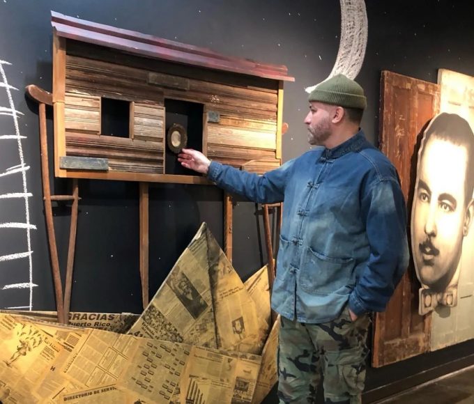 artist Adrián Viajero Román in front of one of this art pieces