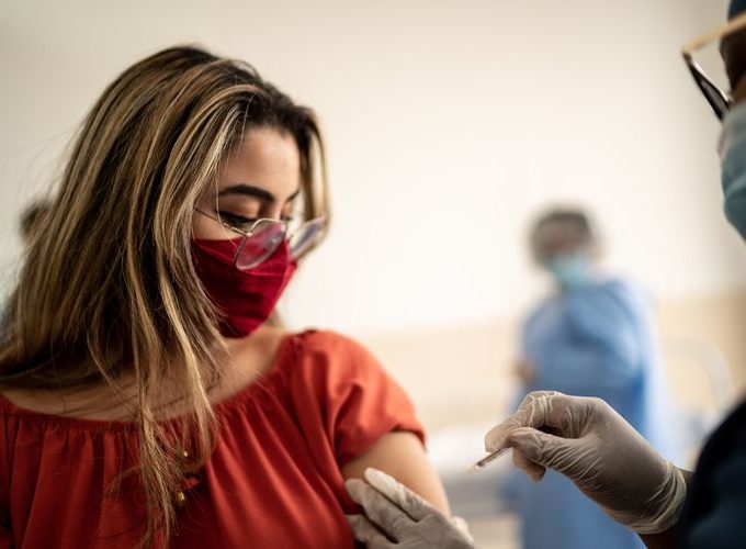 doctor giving patient an HVN vaccine shot