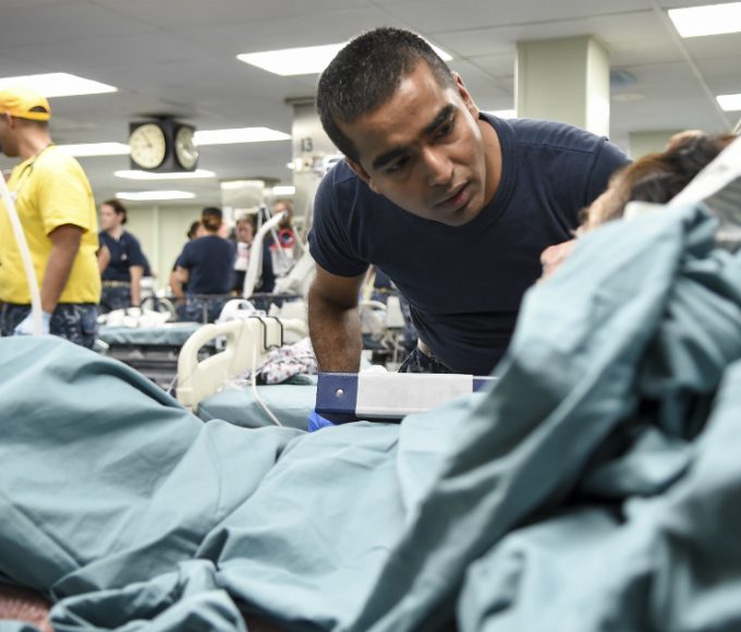 doctor looking over patient