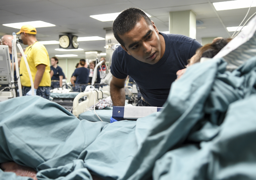 doctor looking over patient